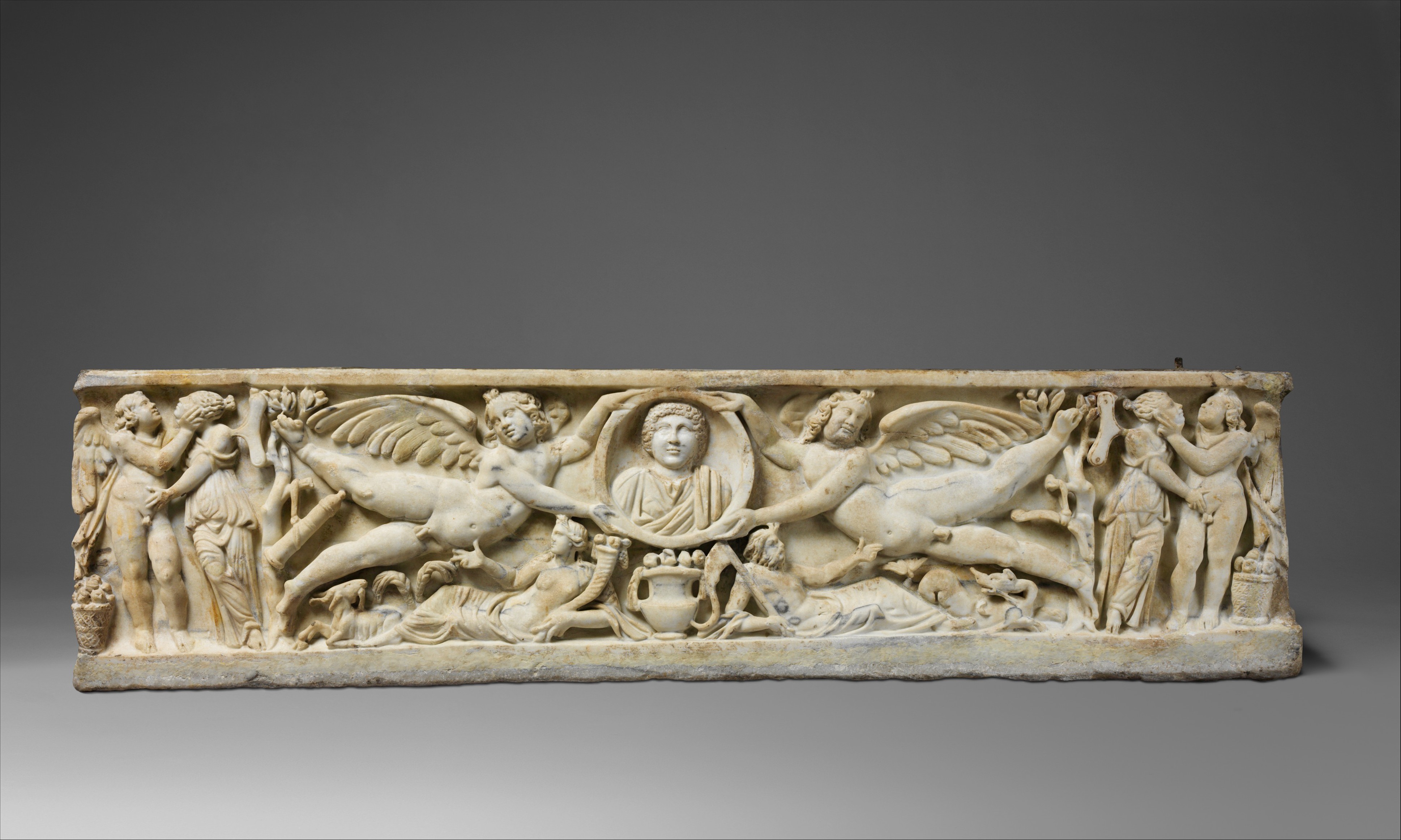 Marble sarcophagus with flying erotes holding a clipeus portrait