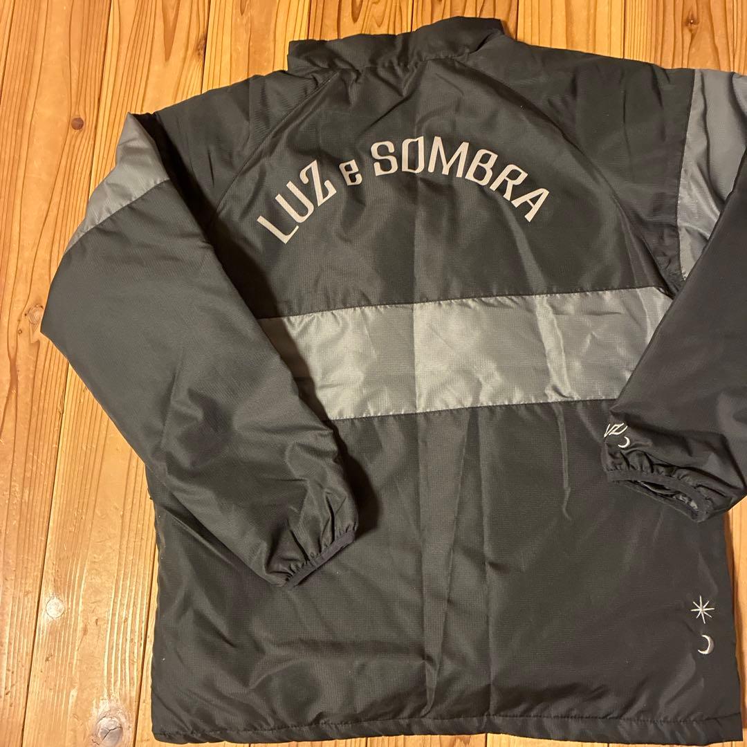 LUZeSOMBRA ピステ・ウィンドブレーカー Sサイズ ブラック・チャコール