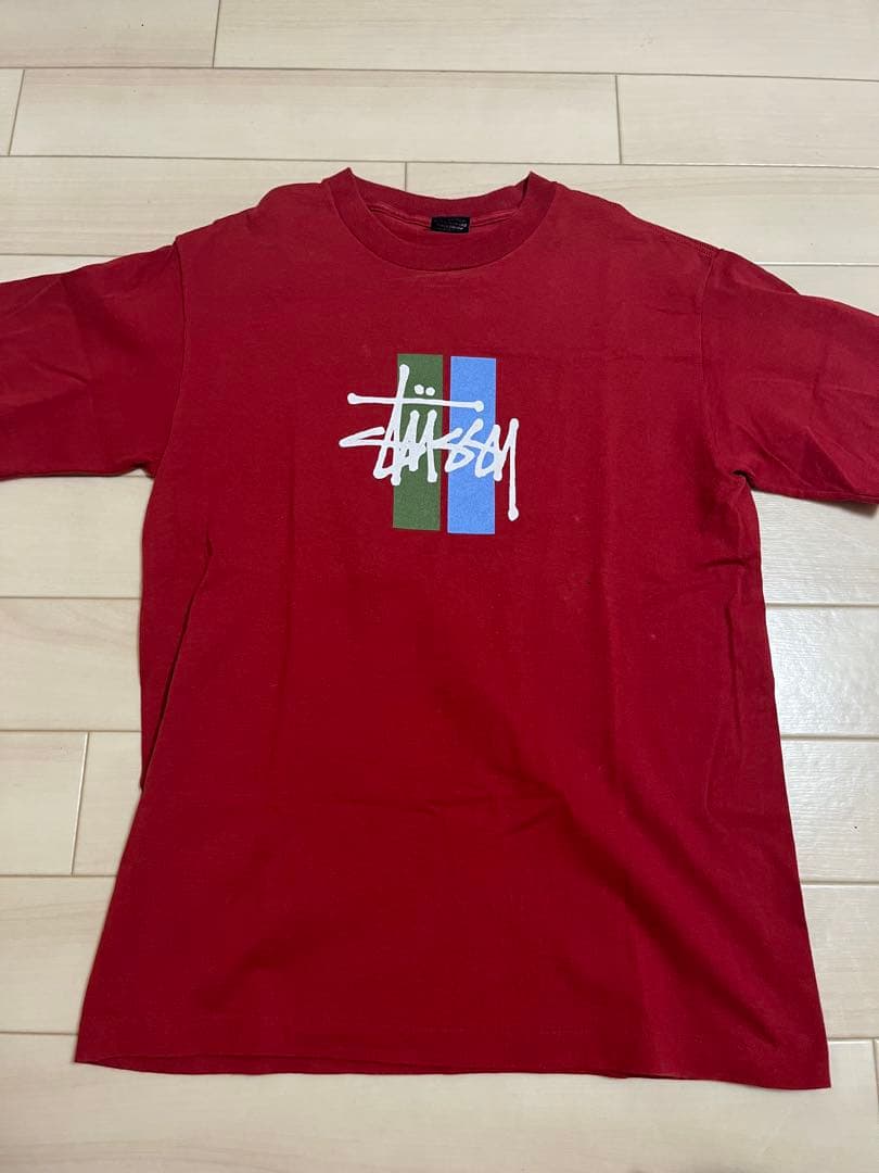 「1997」年制stussy レッド Tシャツ Mサイズ 中古・古着通販】stussy (ステューシー) RASTA CIRCLE LION LOGO T